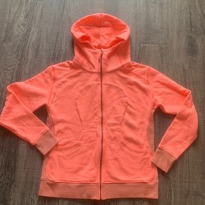 Orange/white Lululemon zip-up scuba hoodie.